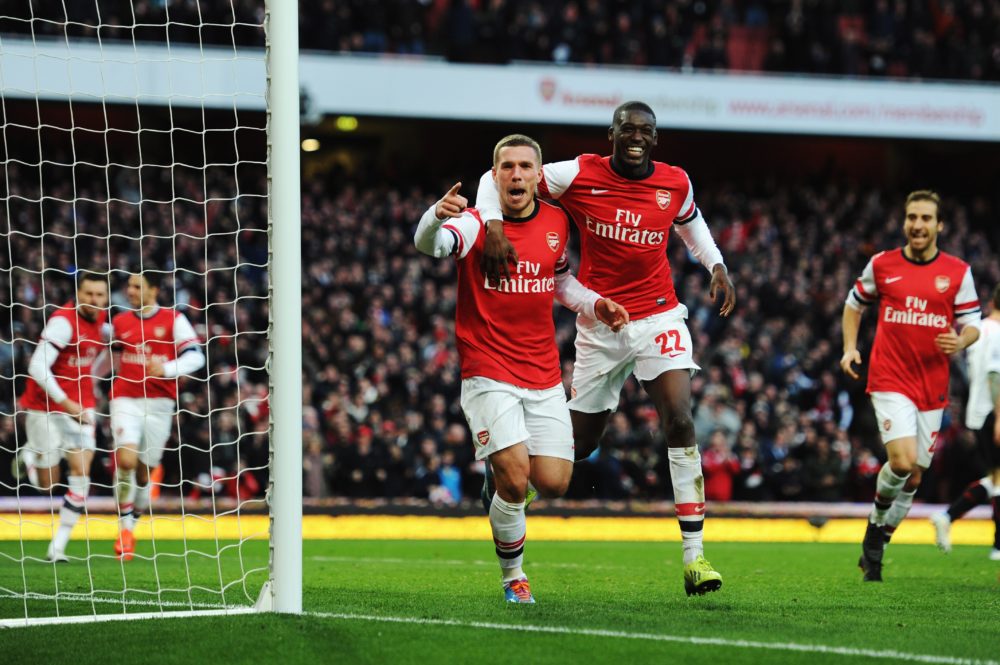 LONDON, ENGLAND - FEBRUARY 16: Lukas Podolski (L) of Arsenal celebrates with team mate Yaya Sanogo after scoring during the FA Cup Fifth Round match between Arsenal and Liverpool at the Emirates Stadium on February 16, 2014, in London, England. (Photo by Shaun Botterill/Getty Images)