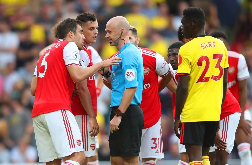 WATFORD, ENGLAND - SEPTEMBER 15: Granit Xhaka and Sokratis Papastathopoulos of Arsenal appeal to referee Anthony Taylor as he awards Watford a penalty during the Premier League match between Watford FC and Arsenal FC at Vicarage Road on September 15, 2019, in Watford, United Kingdom. (Photo by Marc Atkins/Getty Images)