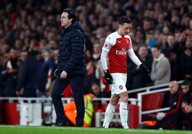 LONDON, ENGLAND - MARCH 10: Mesut Ozil of Arsenal walks past Unai Emery, Manager of Arsenal after being substituted off during the Premier League match between Arsenal FC and Manchester United at Emirates Stadium on March 10, 2019 in London, United Kingdom. (Photo by Julian Finney/Getty Images)