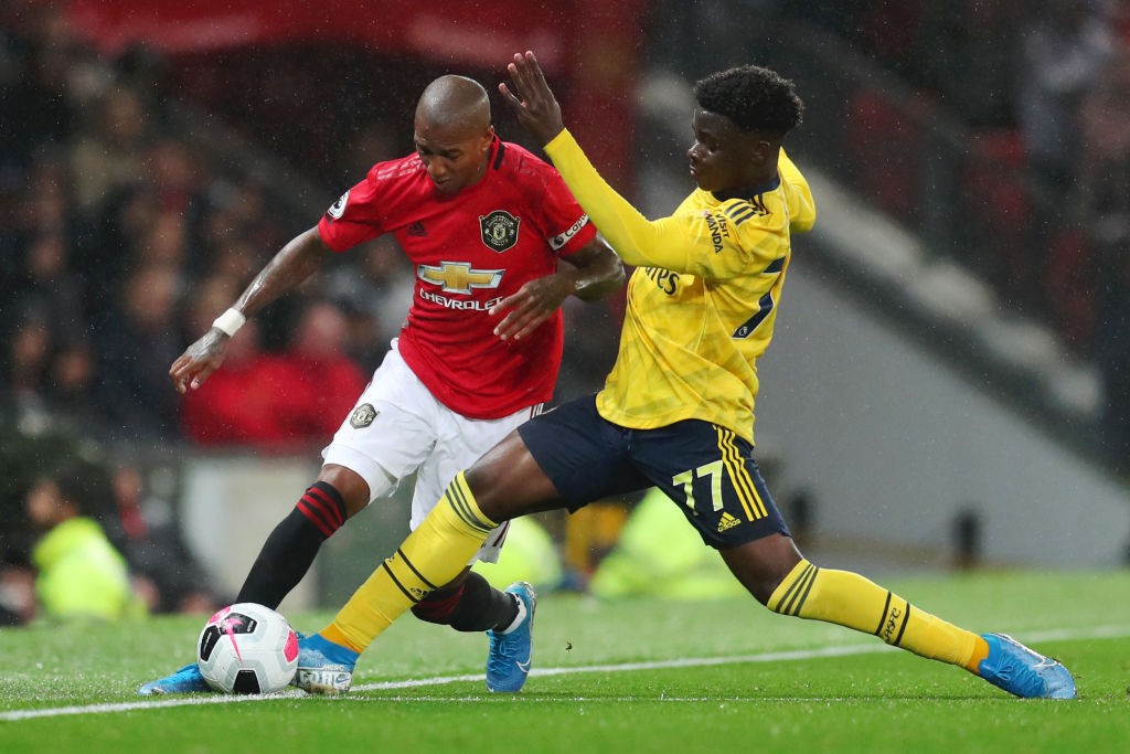 MANCHESTER, ENGLAND - SEPTEMBER 30: Ashley Young of Manchester United battles for possession with Bukayo Saka of Arsenal during the Premier League match between Manchester United and Arsenal FC at Old Trafford on September 30, 2019, in Manchester, United Kingdom. (Photo by Catherine Ivill/Getty Images)