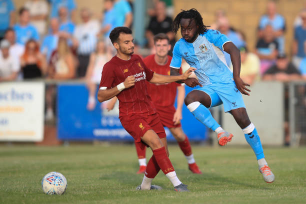RUGBY, ENGLAND - JULY 24: Pedro Chirivella of Liverpool in action with Fankaty Dabo of Coventry City during the Pre-Season Friendly match between Coventry City and Liverpool U23 at Butlin Road on July 24, 2019 in Rugby, England. (Photo by Marc Atkins/Getty Images)