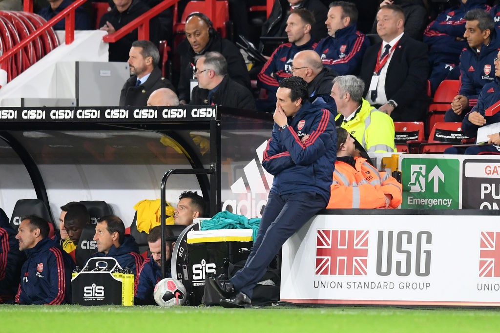 SHEFFIELD, ENGLAND - OCTOBER 21: Unai Emery, Manager of Arsenal sits on an advertising board on the sideline during the Premier League match between Sheffield United and Arsenal FC at Bramall Lane on October 21, 2019, in Sheffield, United Kingdom. (Photo by Michael Regan/Getty Images)