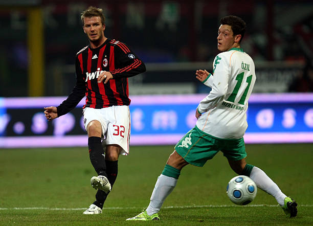 MILAN, ITALY - FEBRUARY 26: David Beckham of Milan is challenged by Mesut Oezil of Bremen during the UEFA Cup Round of 32 second leg match between AC Milan and SV Werder Bremen at the Giuseppe de Meazza stadium on February 26, 2009 in Milan, Italy. (Photo by Lars Baron/Bongarts/Getty Images)