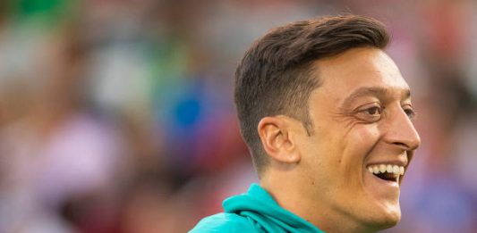 COMMERCE CITY, CO - JULY 15: Mesut Oezil #10 of Arsenal jokes with teammates while warming up against the Colorado Rapids at Dick's Sporting Goods Park on July 15, 2019 in Commerce City, Colorado. (Photo by Timothy Nwachukwu/Getty Images)