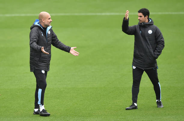 MANCHESTER, ENGLAND - SEPTEMBER 30: Pep Guardiola of Manchester City talks to Mikel Arteta, Assistant Manager of Manchester City during a training session at Manchester City Football Academy on September 30, 2019 in Manchester, England. (Photo by Nathan Stirk/Getty Images)