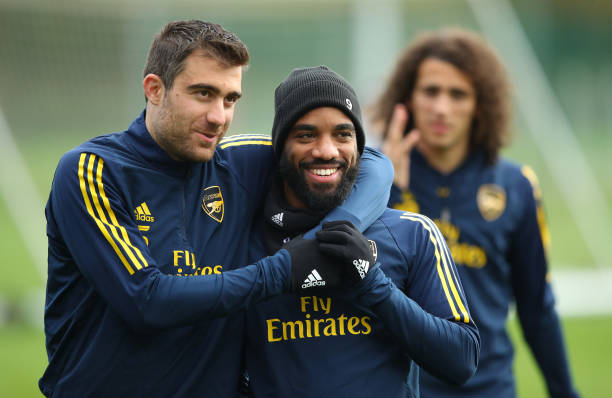 ST ALBANS, ENGLAND - NOVEMBER 27: Sokratis Papastathopoulos jokes with team mate Alexandre Lacazette during an Arsenal training session on the eve of their UEFA Europa League match against Eintracht Frankfurt at London Colney on November 27, 2019 in St Albans, England. (Photo by Warren Little/Getty Images)