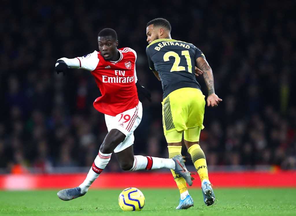 LONDON, ENGLAND - NOVEMBER 23: Nicolas Pepe of Arsenal runs past Ryan Bertrand of Southampton during the Premier League match between Arsenal FC and Southampton FC at Emirates Stadium on November 23, 2019, in London, United Kingdom. (Photo by Julian Finney/Getty Images)