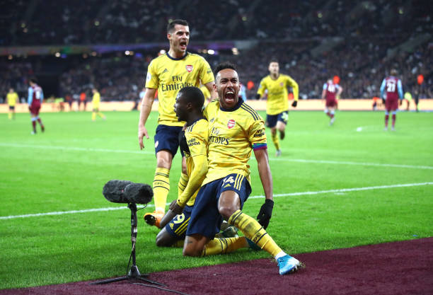 LONDON, ENGLAND - DECEMBER 09: Nicolas Pepe of Arsenal celebrates after scoring his sides second goal with Pierre-Emerick Aubameyang during the Premier League match between West Ham United and Arsenal FC at London Stadium on December 09, 2019 in London, United Kingdom. (Photo by Julian Finney/Getty Images)