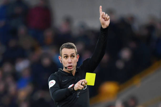 WOLVERHAMPTON, ENGLAND - DECEMBER 01: Referee David Coote shows a yellow card during the Premier League match between Wolverhampton Wanderers and Sheffield United at Molineux on December 01, 2019 in Wolverhampton, United Kingdom. (Photo by Shaun Botterill/Getty Images)