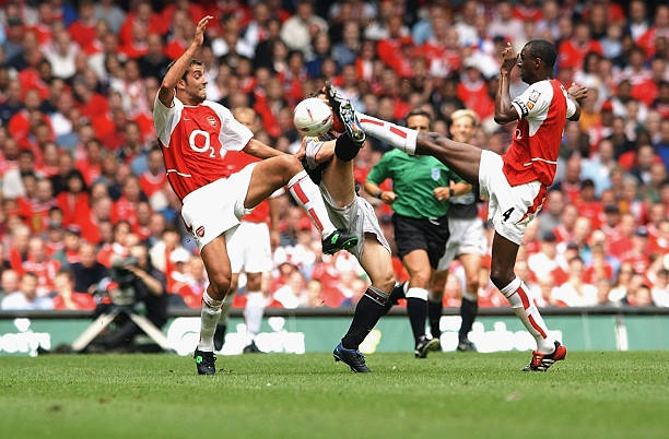 CARDIFF - AUGUST 11:  Michael Owen of Liverpool and Patrick Vieira and Edu of Arsenal challge for the ball  during the FA Community Shield between Arsenal and Liverpool at the Millennium Stadium in Cardiff, Wales on August 11, 2002. (Photo by Shaun Botterill/Getty Images) Arsenal won the match 1-0.