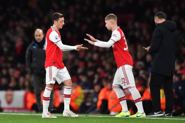 Arsenal's German midfielder Mesut Ozil (L) is substituted for Arsenal's English midfielder Emile Smith Rowe (R) during the English Premier League football match between Arsenal and Manchester City at the Emirates Stadium in London on December 15, 2019. (Photo by Ben STANSALL / AFP)