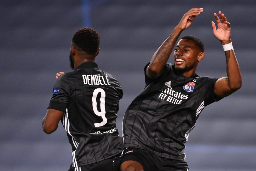 Lyon's French forward Moussa Dembele (L) celebrates with Lyon's French midfielder Jeff Reine-Adelaide after scoring his second goal during the UEFA Champions League quarter-final football match between Manchester City and Lyon at the Jose Alvalade stadium in Lisbon on August 15, 2020. (Photo by FRANCK FIFE / POOL / AFP)