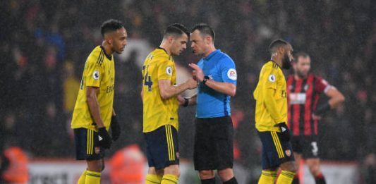 BOURNEMOUTH, ENGLAND - DECEMBER 26: Match referee Stuart Attwell speaks to Granit Xhaka of Arsenal during the Premier League match between AFC Bournemouth and Arsenal FC at Vitality Stadium on December 26, 2019 in Bournemouth, United Kingdom. (Photo by Dan Mullan/Getty Images)