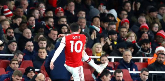 LONDON, ENGLAND - DECEMBER 15: Mesut Ozil of Arsenal kicks a water bottle as he is subbed as Interim Manager of Arsenal, Freddie Ljungberg looks on during the Premier League match between Arsenal FC and Manchester City at Emirates Stadium on December 15, 2019 in London, United Kingdom. (Photo by Julian Finney/Getty Images)