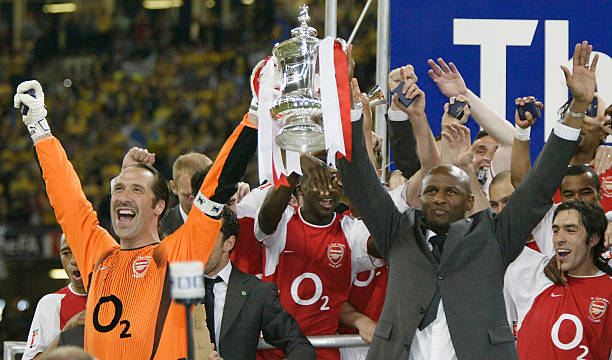 CARDIFF, WALES - MAY 17: David Seaman and Patrick Vieira of Arsenal lift the FA Cup after a 1-0 victory over Southampton during the FA Cup Final between Arsenal and Southampton at the Millennium Stadium on May 17, 2003 in Cardiff. (Photo by Ross Kinnaird/Getty Images)