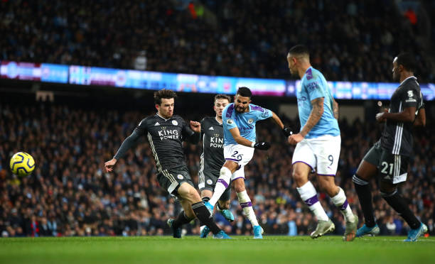 MANCHESTER, ENGLAND - DECEMBER 21: Riyad Mahrez of Manchester City shoots during the Premier League match between Manchester City and Leicester City at Etihad Stadium on December 21, 2019 in Manchester, United Kingdom. (Photo by Clive Brunskill/Getty Images)
