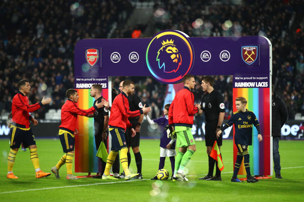 LONDON, ENGLAND - DECEMBER 09: The two sides shake hands infront of Stonewall Rainbow laces branding during the Premier League match between West Ham United and Arsenal FC at London Stadium on December 09, 2019 in London, United Kingdom. (Photo by Julian Finney/Getty Images)