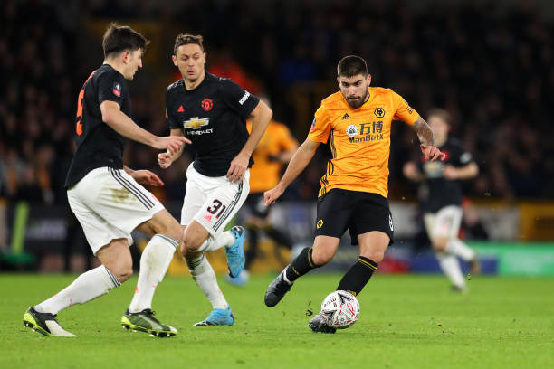 WOLVERHAMPTON, ENGLAND - JANUARY 04: Ruben Neves of Wolverhampton Wanderers battles for possession with Harry Maguire of Manchester United during the FA Cup Third Round match between Wolverhampton Wanderers and Manchester United at Molineux on January 04, 2020 in Wolverhampton, England. (Photo by Catherine Ivill/Getty Images)