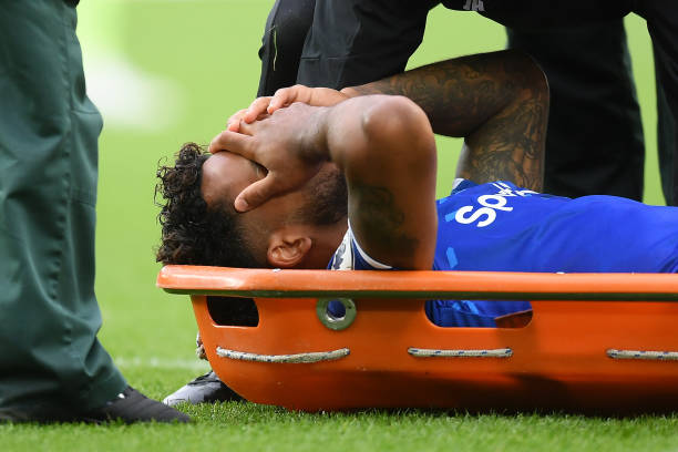 LIVERPOOL, ENGLAND - SEPTEMBER 28: Theo Walcott of Everton receives medical treatment after he is hit on the head from a ball after a cross by Raheem Sterling of Manchester City during the Premier League match between Everton FC and Manchester City at Goodison Park on September 28, 2019 in Liverpool, United Kingdom. (Photo by Michael Regan/Getty Images)