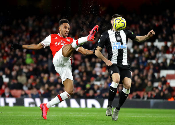 Pierre-Emerick Aubameyang of Arsenal and Federico Fernandez of Newcastle United during the Premier League match between Arsenal FC and Newcastle United at Emirates Stadium on February 16, 2020 in London, United Kingdom.