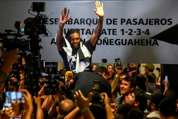 Togo's football player Emmanuel Adebayor waves to Paraguay's Olimpia football fans upon his arrival at the Silvio Pettirossi Airport on February 14, 2020 in Luque, Paraguay. 