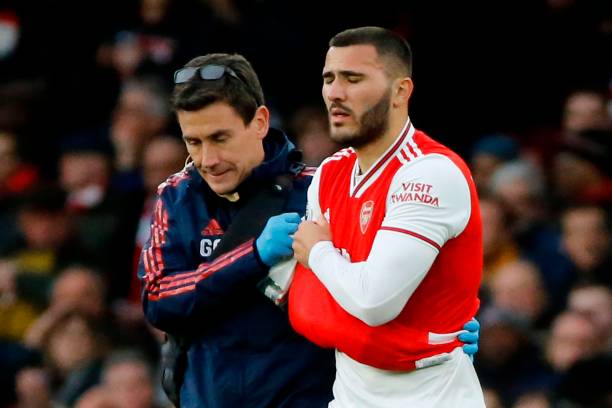 Arsenal's German-born Bosnian defender Sead Kolasinac (R) goes off with an injury during the English Premier League football match between Arsenal and Everton at the Emirates Stadium in London on February 23, 2020.