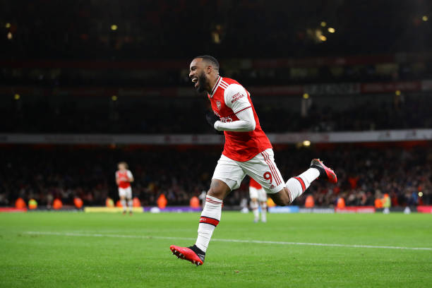 Alexandre Lacazette of Arsenal celebrates after scoring his sides fourth goal during the Premier League match between Arsenal FC and Newcastle United at Emirates Stadium on February 16, 2020 in London, United Kingdom.