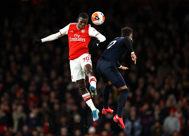 Eddie Nketiah of Arsenal jumps for a header with Mason Holgate of Everton during the Premier League match between Arsenal FC and Everton FC at Emirates Stadium on February 23, 2020 in London, United Kingdom.