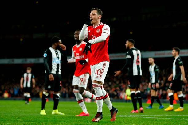 Arsenal's German midfielder Mesut Ozil (C) celebrates after scoring their third goal during the English Premier League football match between Arsenal and Newcastle United at the Emirates Stadium in London on February 16, 2020.
