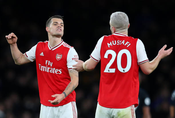 Granit Xhaka and Shkodran Mustafi of Arsenal in conversation at full-time during the Premier League match between Arsenal FC and Everton FC at Emirates Stadium on February 23, 2020 in London, United Kingdom.