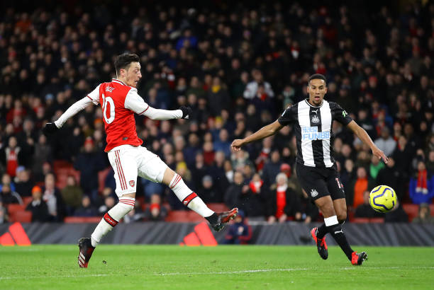 LONDON, ENGLAND - FEBRUARY 16: Mesut Ozil of Arsenal scores his sides third goal during the Premier League match between Arsenal FC and Newcastle United at Emirates Stadium on February 16, 2020 in London, United Kingdom. (Photo by Richard Heathcote/Getty Images)