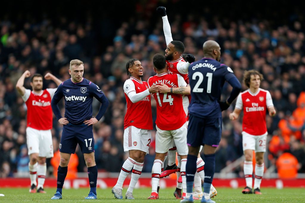 Arsenal's French striker Alexandre Lacazette (C) celebrates with teammates after scoring the opening goal of the English Premier League football match between Arsenal and West Ham at the Emirates Stadium in London on March 7, 2020.