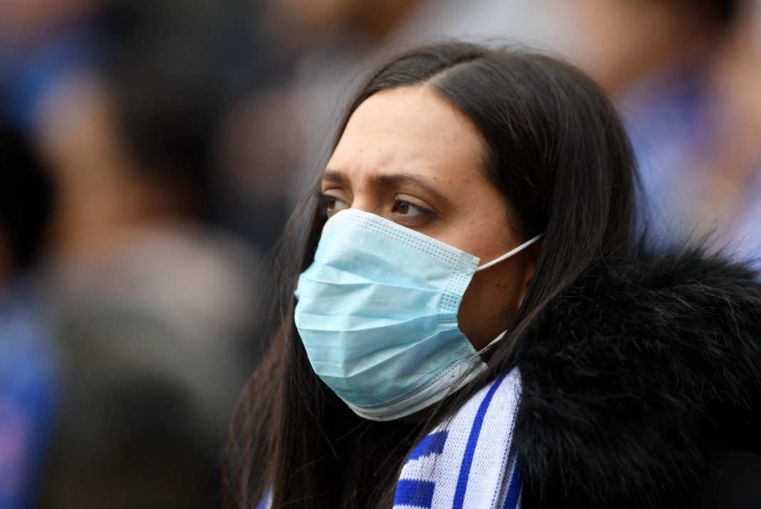 A fan is seen wearing a disposable face mask prior to the Premier League match between Chelsea FC and Everton FC at Stamford Bridge on March 08, 2020 in London, United Kingdom.