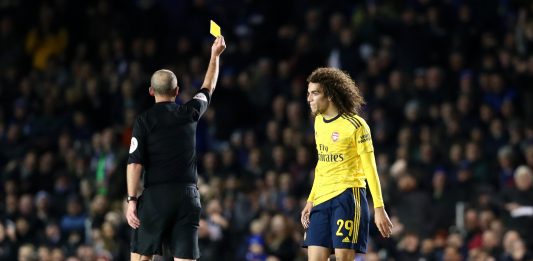 Matteo Guendouzi of Arsenal is shown a yellow card by referee Mike Dean during the FA Cup Fifth Round match between Portsmouth FC and Arsenal FC at Fratton Park on March 02, 2020 in Portsmouth, England.
