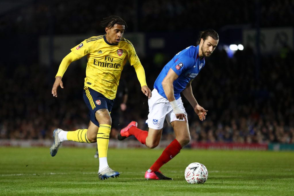 Christian Burgess of Portsmouth FC battles for possession with Reiss Nelson of Arsenal during the FA Cup Fifth Round match between Portsmouth FC and Arsenal FC at Fratton Park on March 02, 2020 in Portsmouth, England.