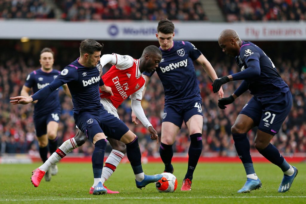 Arsenal's French-born Ivorian midfielder Nicolas Pepe (C) vies with West Ham United's English defender Aaron Cresswell (2nd L) West Ham United's English midfielder Declan Rice (2nd R0 and West Ham United's Italian defender Angelo Ogbonna (R) during the English Premier League football match between Arsenal and West Ham at the Emirates Stadium in London on March 7, 2020.