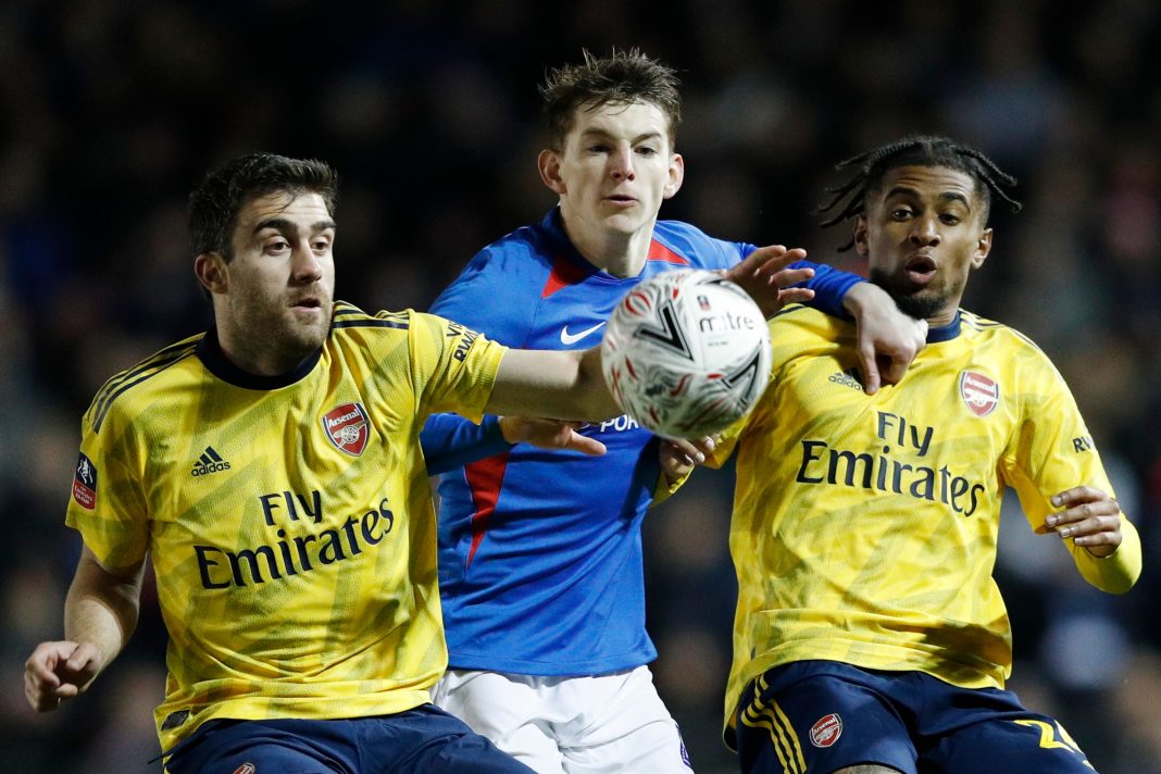 Arsenal's Greek defender Sokratis Papastathopoulos (L) and Arsenal's English midfielder Reiss Nelson (R) tangle with Portsmouth's English defender Steve Seddon (C) during the English FA Cup fifth round football match between Portsmouth and Arsenal at Fratton Park stadium in Portsmouth, southern England, on March 2, 2020.