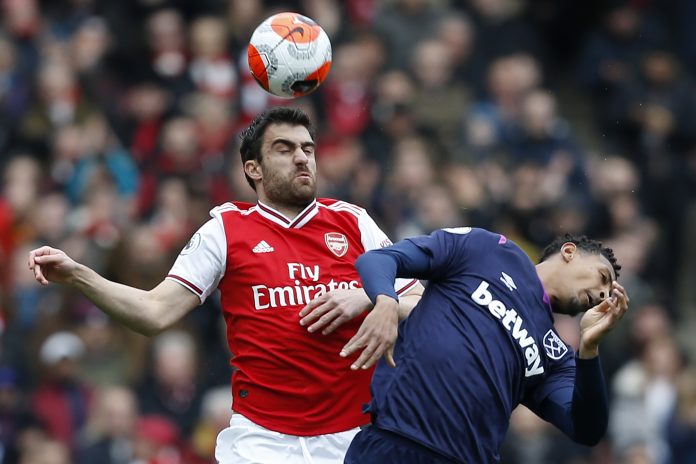 Arsenal's Greek defender Sokratis Papastathopoulos (L) vies with West Ham United's French striker Sebastien Haller (R) during the English Premier League football match between Arsenal and West Ham at the Emirates Stadium in London on March 7, 2020.