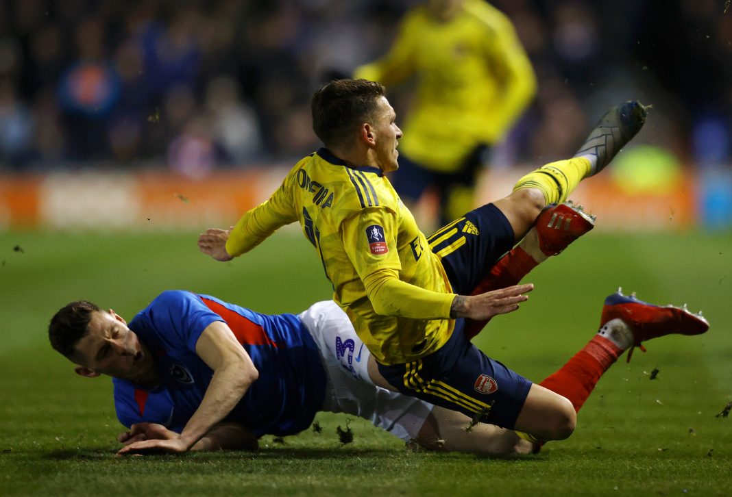 Lucas Torreira of Arsenal is tackled by James Bolton of Portsmouth FC which leads to Lucas Torreira being stretchered off due to injury during the FA Cup Fifth Round match between Portsmouth FC and Arsenal FC at Fratton Park on March 02, 2020 in Portsmouth, England.