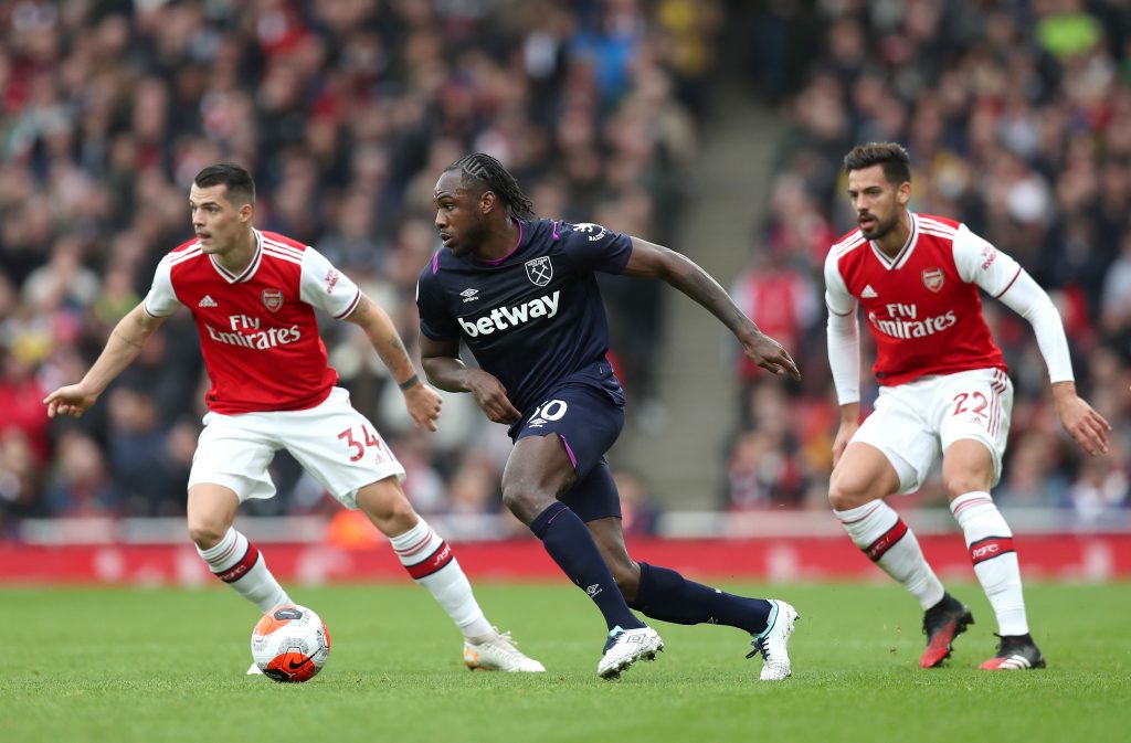 Michail Antonio of West Ham United battles for possession with Granit Xhaka and Pablo Mari of Arsenal during the Premier League match between Arsenal FC and West Ham United at Emirates Stadium on March 07, 2020 in London, United Kingdom.