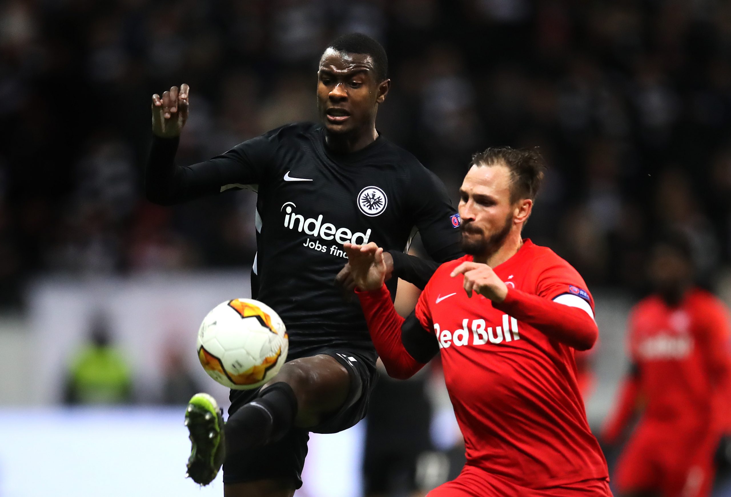 FRANKFURT AM MAIN, GERMANY - FEBRUARY 20: Evan N'Dicka of Eintracht Frankfurt controls the ball with pressure from Andreas Ulmer of RB Salzburg during the UEFA Europa League round of 32 first leg match between Eintracht Frankfurt and RB Salzburg at Commerzbank Arena on February 20, 2020, in Frankfurt am Main, Germany. (Photo by Alex Grimm/Bongarts/Getty Images)