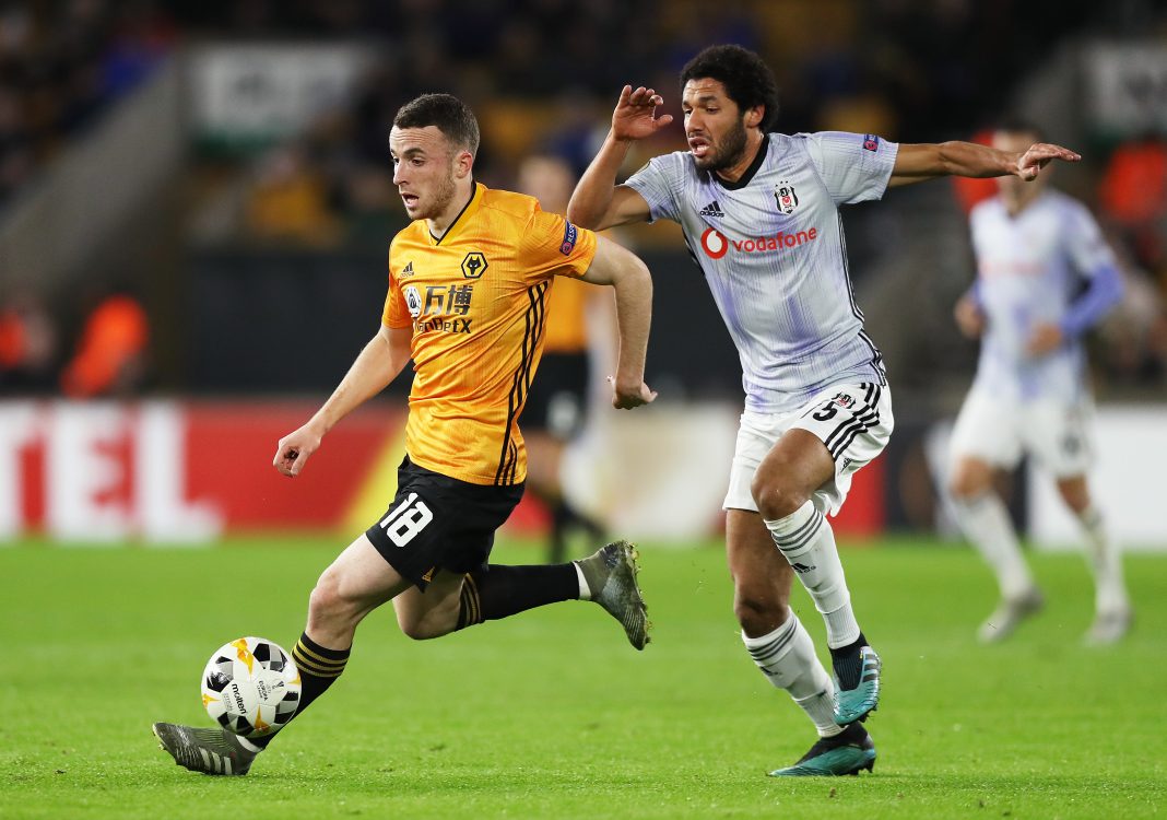 WOLVERHAMPTON, ENGLAND - DECEMBER 12: Diogo Jota of Wolverhampton Wanderers runs with the ball past Mohamed Elneny of Besiktas during the UEFA Europa League group K match between Wolverhampton Wanderers and Besiktas at Molineux on December 12, 2019, in Wolverhampton, United Kingdom. (Photo by David Rogers/Getty Images)