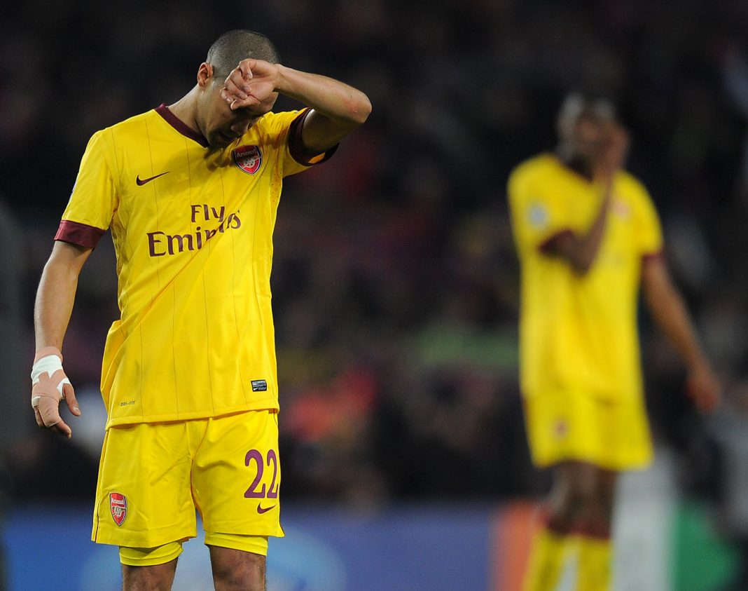 Arsenal's French player Gael Clichy gestures after lossig 3-1 their Champions League round of 16, 2nd leg football match FC Barcelona vs Arsenal on March 8, 2011 at Camp Nou stadium in Barcelona. AFP PHOTO / LLUIS GENE