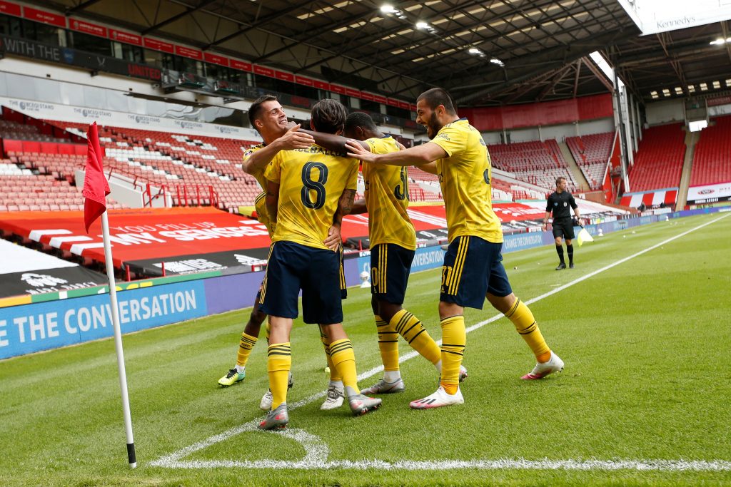 Arsenal players join Dani Ceballos (C) after he scored the winning goal during the English FA Cup quarter-final football match between Sheffield United and Arsenal at Bramall Lane in Sheffield, northern England on June 28, 2020. (Photo by ANDREW BOYERS / POOL / AFP) / RESTRICTED TO EDITORIAL USE. No use with unauthorized audio, video, data, fixture lists, club/league logos or 'live' services. Online in-match use limited to 120 images. An additional 40 images may be used in extra time. No video emulation. Social media in-match use limited to 120 images. An additional 40 images may be used in extra time. No use in betting publications, games or single club/league/player publications. / (Photo by ANDREW BOYERS/POOL/AFP via Getty Images)