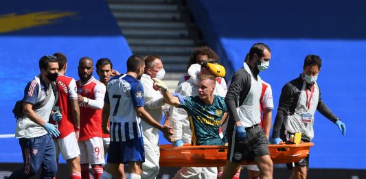 Arsenal's German goalkeeper Bernd Leno (on stretcher) remonstrates with Brighton's French striker Neal Maupay after the keeper was injured during the English Premier League football match between Brighton and Hove Albion and Arsenal at the American Express Community Stadium in Brighton, southern England on June 20, 2020. (Photo by Mike Hewitt / POOL / AFP)