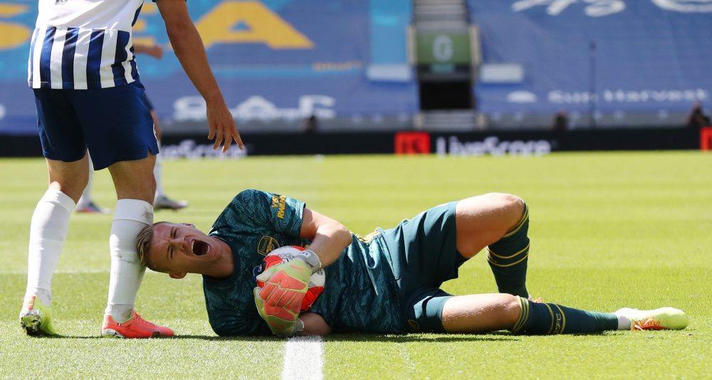 Arsenal's German goalkeeper Bernd Leno (R) lies on the ground next to Brighton's French striker Neal Maupay during the English Premier League football match between Brighton and Hove Albion and Arsenal at the American Express Community Stadium in Brighton, southern England on June 20, 2020. (Photo by Gareth Fuller / POOL / AFP)