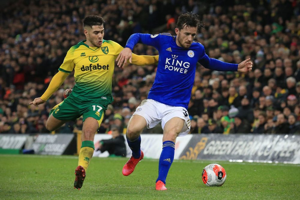 Norwich City's Argentinian midfielder Emiliano Buendía (L) vies for the ball against Leicester City's English defender Ben Chilwell (R) during the English Premier League football match between Norwich City and Leicester City at Carrow Road in Norwich, eastern England on February 28, 2020. (Photo by Lindsey Parnaby / AFP)