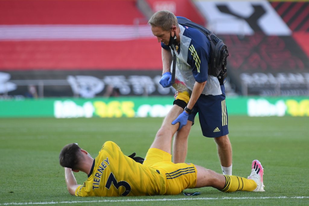 Arsenal's Scottish defender Kieran Tierney receives medical treatment during the English Premier League football match between Southampton and Arsenal at St Mary's Stadium in Southampton, southern England on June 25, 2020. (Photo by Mike Hewitt / POOL / AFP) / RESTRICTED TO EDITORIAL USE. No use with unauthorized audio, video, data, fixture lists, club/league logos or 'live' services. Online in-match use limited to 120 images. An additional 40 images may be used in extra time. No video emulation. Social media in-match use limited to 120 images. An additional 40 images may be used in extra time. No use in betting publications, games or single club/league/player publications. / (Photo by MIKE HEWITT/POOL/AFP via Getty Images)