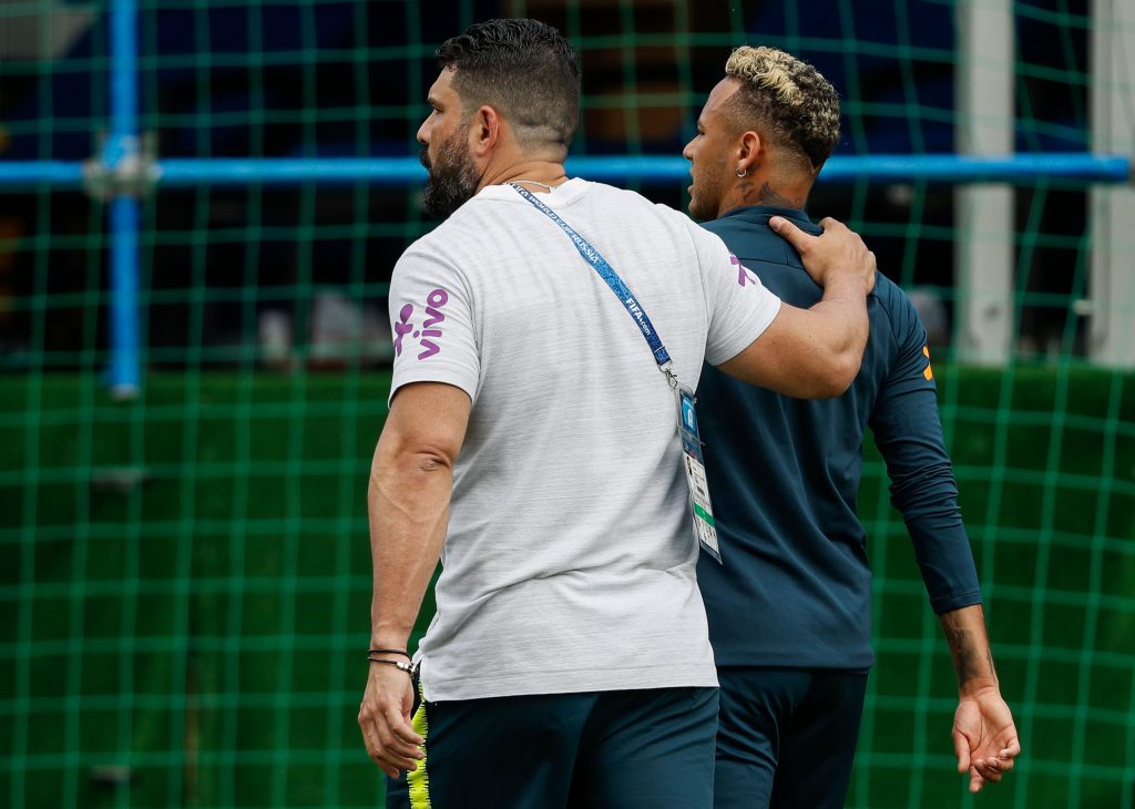 Brazil's forward Neymar is comforted by team physio Bruno Mazziotti as he leaves the practice during a training session of Brazil national football team at Yug Sport Stadium, in Sochi, on June 19, 2018, ahead of the Russia 2018 World Cup football tournament. (Photo by Adrian DENNIS / AFP) (Photo credit should read ADRIAN DENNIS/AFP via Getty Images)