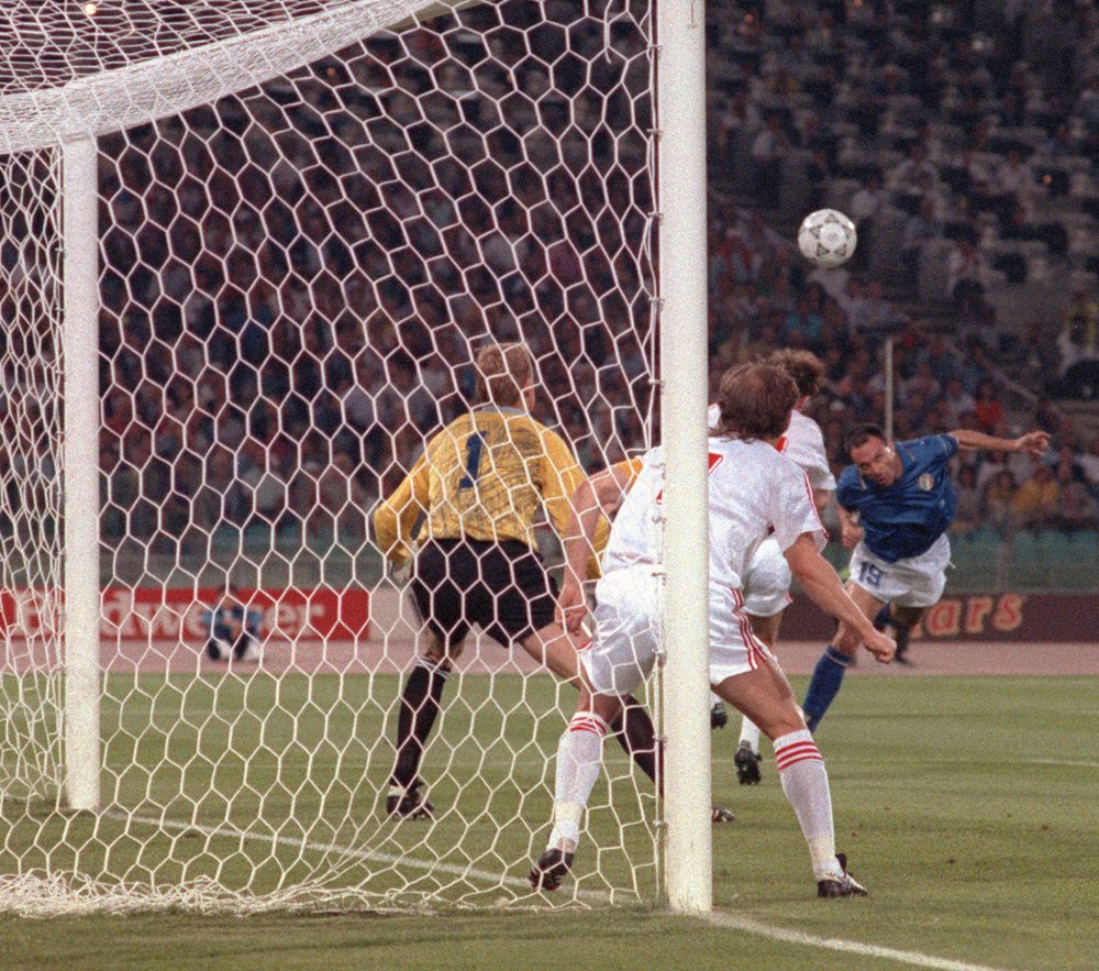 ROME, ITALY: Italian forward Salvatore Schillaci (R) scores his team's first goal on a header past Czech goalkeeper Jan Stejsk during the World Cup first round soccer match between Italy and Czechoslovakia 19 June 1990 in Rome. Italy won 2-0. AFP PHOTO/DANIEL GARCIA